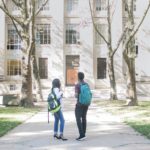 a couple of people that are standing in front of a building